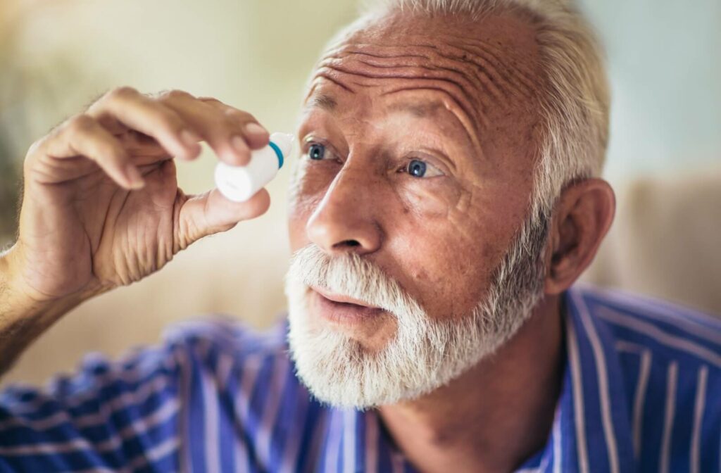 A senior tilts their head back and keeps their eyes open while applying prescription eye drops to treat glaucoma.